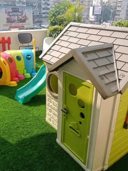 Even a balcony can become a mini-playground. This setup includes a playhouse, a caterpillar tunnel for crawling adventures, and a small slide, proving you don't need a huge lawn to create a fun zone for your kids.