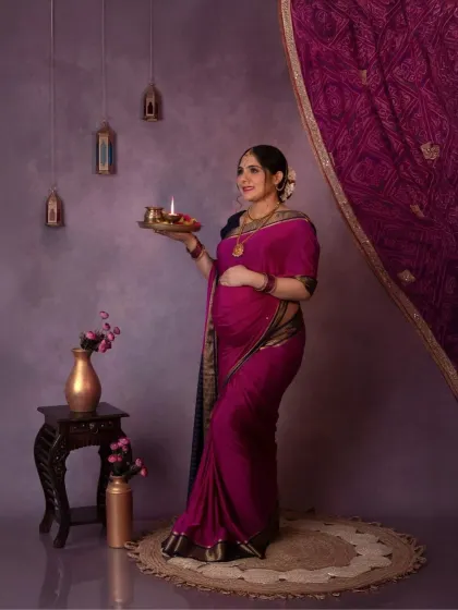 A solo portrait of the mama-to-be holding a diya, a symbol of light and hope. Her expression is serene and full of grace.