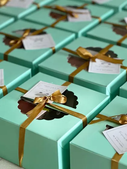 A closer look at the naming ceremony favor boxes, showing the custom tag and gold ribbon.