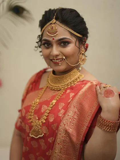 A close-up of a beautiful bride wearing a traditional gold-plated choker and haram. The intricate designs are perfect for a classic wedding look.