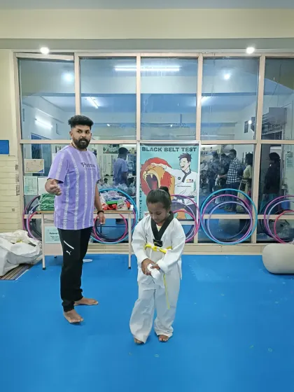 A young student after receiving her yellow belt.