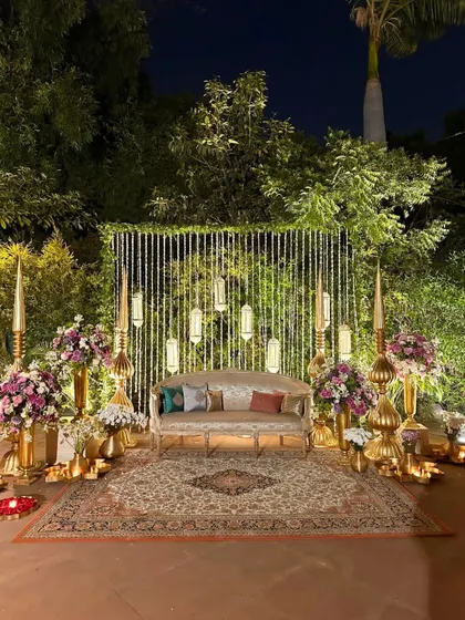 I believe a backdrop should be more than just a photo spot, it should be a piece of art. Here, soft lights, warm brass, and lush florals come together to create a perfect stage for wedding memories.