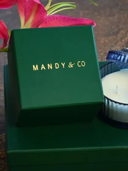 The vanilla-scented ribbed glass soy candle, unboxed to show its elegant container. This is a timeless gift that fits any decor style.