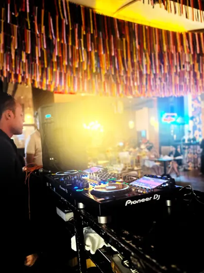 A wider view of the DJ console and the warm, inviting ambiance of the lounge. My setup is clean and professional, fitting seamlessly into any venue.
