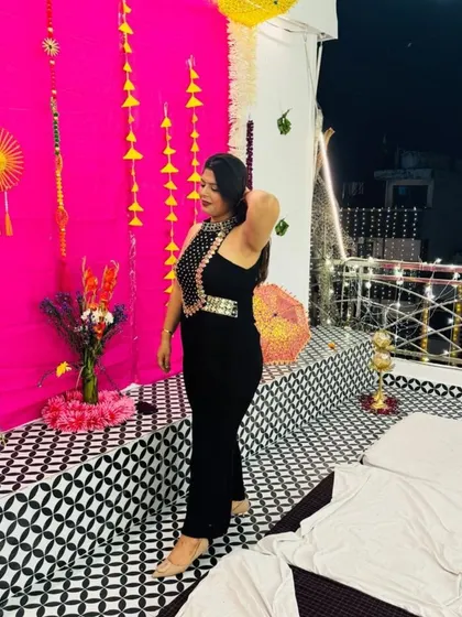 A side view of the black jumpsuit, showing its flattering silhouette. This is a must-have piece for any modern woman's wardrobe.