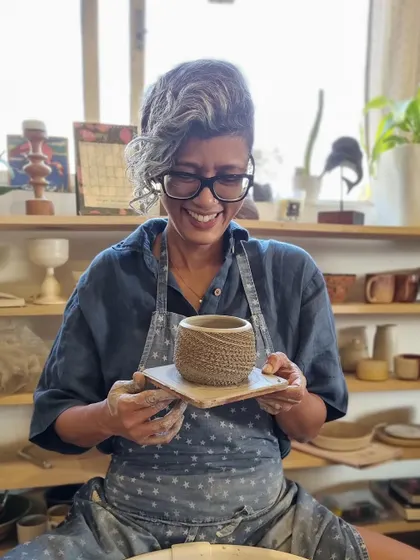 Another shot of me in the studio, smiling with a finished piece. The community and energy here are a constant source of joy and motivation.
