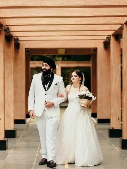 A candid walking shot of the couple after their ceremony, looking elegant and happy.