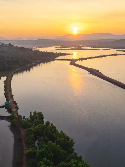 A duplicate of image 16, a serene and symmetrical reflection of a sunset over coastal backwaters.