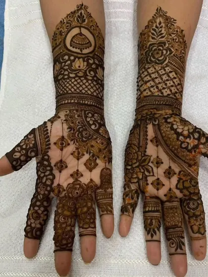 A beautiful design combining jhumka and lotus motifs. The different patterns on each hand make it unique and interesting.