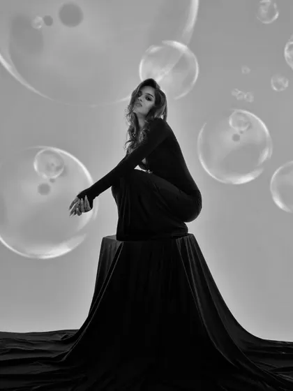 A dreamy black and white portrait with a bubble overlay. This adds a whimsical and artistic touch to a classic studio shot.