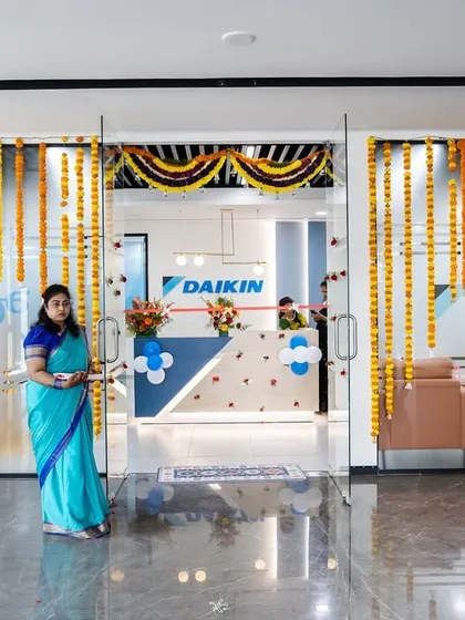 The entrance to the new Daikin office we designed, decorated for its inauguration. The design features clean glass doors with brand logos, setting a professional tone from the moment of arrival.
