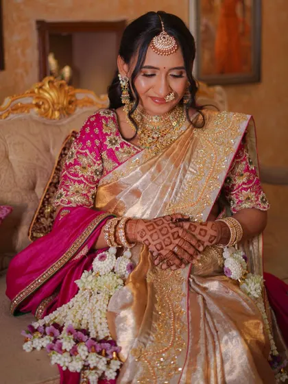 A close-up shot showing the intricate details of the bride's jewellery and our delicate floral accessories, which were designed to match her pink and gold saree.