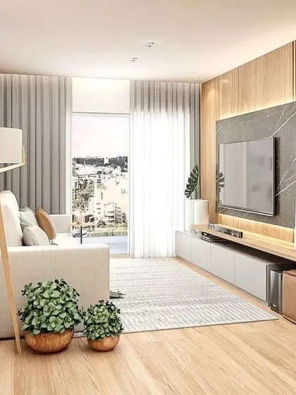 A full view of the living room, showing how the light wood tones and natural light create a warm and inviting atmosphere.