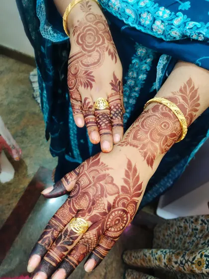 A close-up of the rich, dark stain on a client's hands. The design is clear and the color is deep, just as it should be.