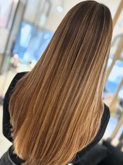 Here is the same honey blonde balayage, styled straight. This shows how the color looks just as seamless and beautiful without waves, highlighting the glossy, healthy finish.