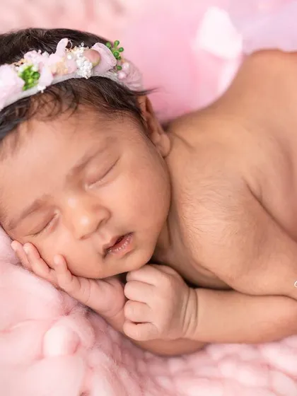A close-up of the newborn fairy, showcasing her delicate features and the soft, dreamy quality of the photograph.