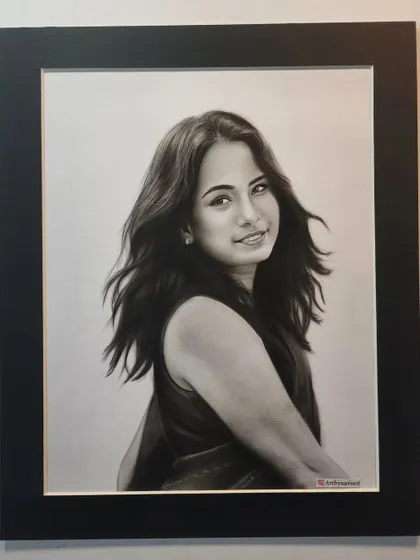 The finished portrait in a black frame, ready to be displayed.