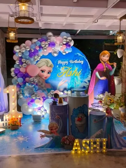A Frozen party setup in a venue with rustic elements, showing how I adapt themes to different spaces.