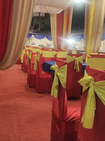 We take care of the seating arrangements too. Here you can see the guest dining area set up with clean table linens and decorated chair covers.