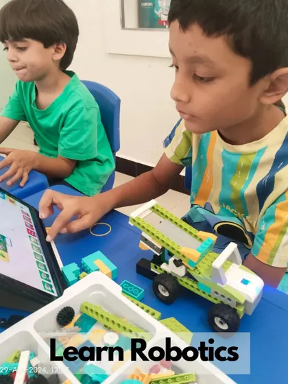 Students learn robotics by building and coding their own models, like this truck, using tablets to program its movements.