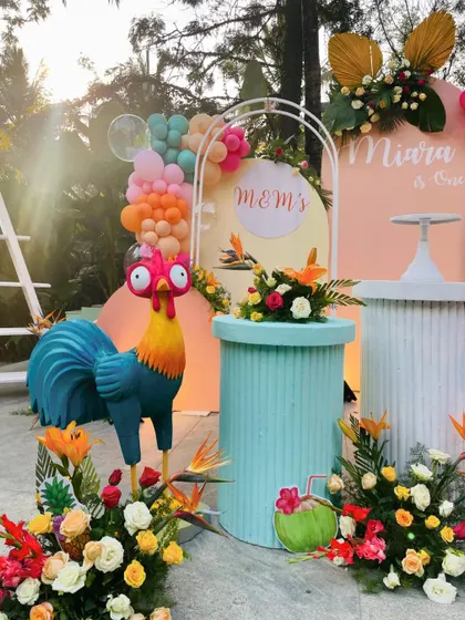 A detailed shot of the Moana decor, highlighting the Heihei the rooster prop and the colorful tropical flowers.