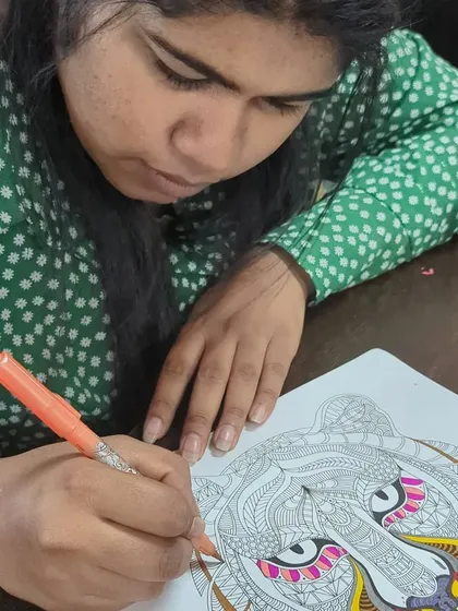 A participant coloring an intricate tiger design. Our DIY menu offers a range of relaxing activities.