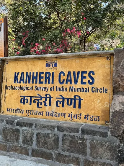 The official Archaeological Survey of India sign at the entrance to the Kanheri Caves heritage site.