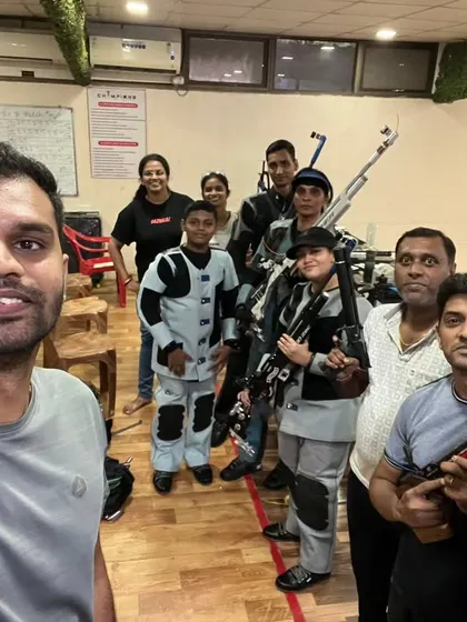A selfie of our team at the range. We are more than just a team; we are a community of shooters and coaches supporting each other.
