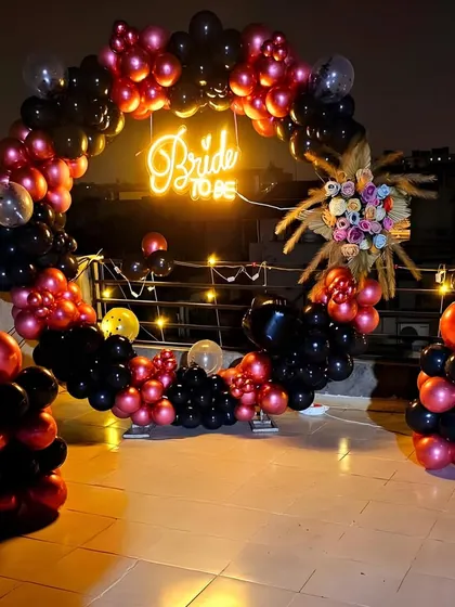 The combination of a balloon arch and a neon sign is one of our most requested photo backdrop designs.