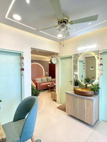 This view shows the flow from the dining nook to the living room. The consistent use of pastel colors and natural elements creates a harmonious and peaceful atmosphere throughout the home.