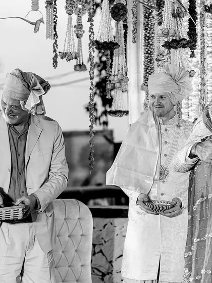 A black and white shot of the families together during the ceremony. It captures the joy and union of two families becoming one.