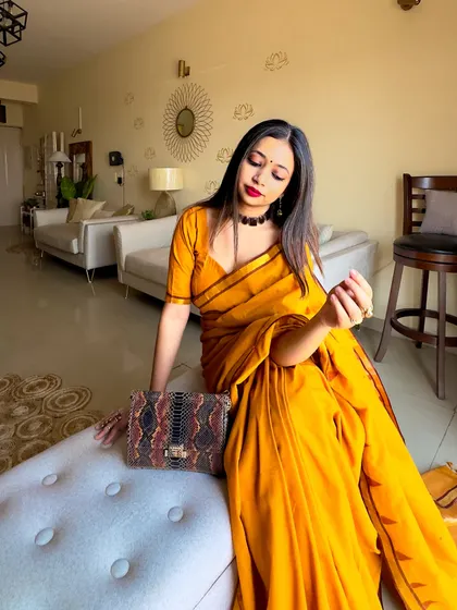 A final seated pose, showing how all the elements of the look come together. This is a great example of a beginner-friendly yet stunning saree look.