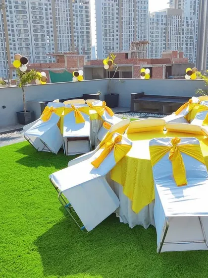 We also handle smaller, private parties in unique locations. This rooftop birthday celebration shows our ability to create a cheerful and organized setting with themed yellow and white decor on an artificial turf lawn, perfect for intimate gatherings.