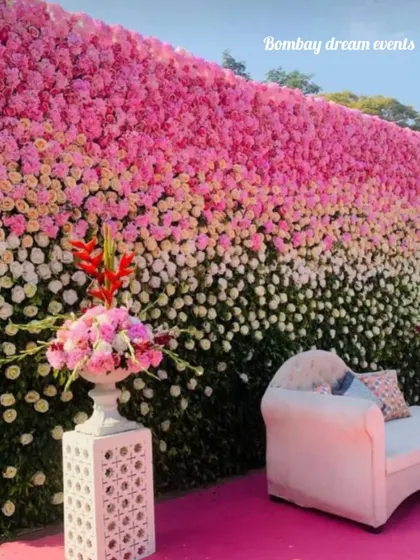 A stunning floral backdrop wall with an ombre effect, transitioning from dark green to white and pink. This is a luxurious option for baby showers, engagements, or any elegant event.