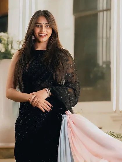 Sapthami Gowda looking elegant and chic in a custom black sequin saree.