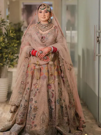 A full-length portrait of the bride in her exquisite pastel lehenga, looking like a modern princess.