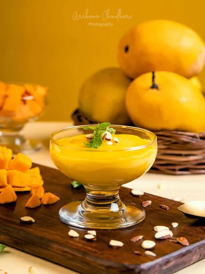 A clean, static shot of the finished mango dessert. This type of image is perfect for menus or features where the dish itself is the hero, presented beautifully with a garnish of mint and almonds.