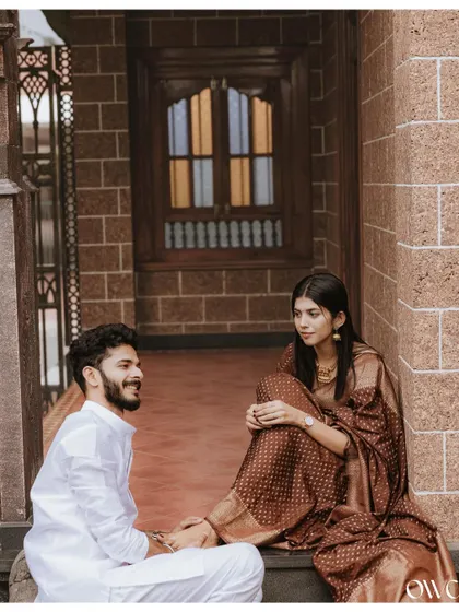 A candid conversation on the steps of a traditional brick building, this pre-wedding photo has a timeless, story-like quality.