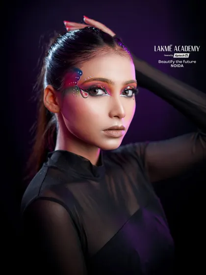A full portrait of the butterfly-inspired eye makeup. The high ponytail and simple outfit keep the focus on the intricate and beautiful eye art.