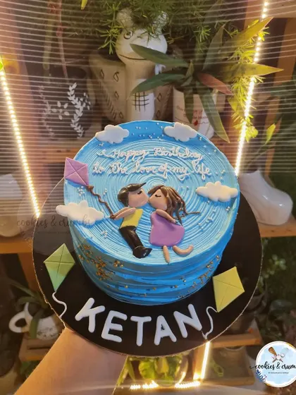 A romantic, custom cake showing a couple flying a kite. This was a special request that I loved bringing to life with hand-piped details and fondant figures.