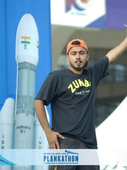 On stage at the Plankathon, with a model of an ISRO rocket in the background. It was an honor to be part of an event that celebrated both fitness and national pride.