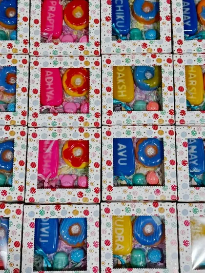 Our personalized name soaps are a huge hit for kids' birthday return gifts. Each box is a fun dessert-themed hamper with custom name soaps, donut soaps, and other little treats, making every child feel special.