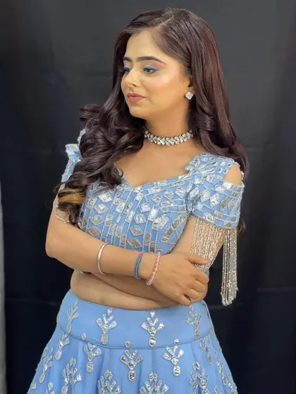 A close-up of this beautiful powder blue lehenga with silver work and trendy cold-shoulder sleeves with tassels.