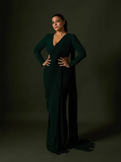 A powerful stance in the custom green saree, showcasing its clean lines and elegant, floor-sweeping drape.