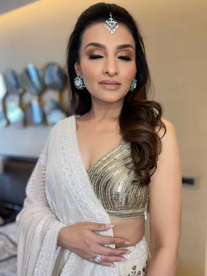 The bride's smokey eye makeup is perfectly complemented by her soft, wavy hair.