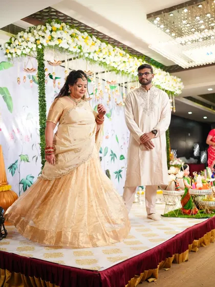 Swetha on stage at her engagement, her custom lehenga twirling beautifully.