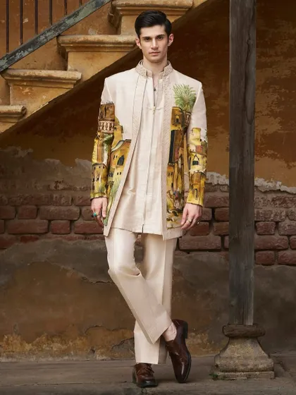 This hand-painted sherwani captures the essence of an Arabian desert landscape. Created in collaboration with Jayesh and Kajal Shah, the artwork wraps around the garment, telling a story of ancient architecture and serene palms.