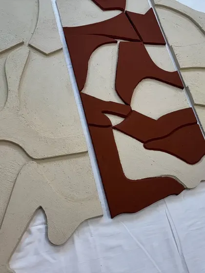 A version of the multi-panel sculpture with a terracotta-colored central panel. This demonstrates how the same design can be customized with different color combinations.