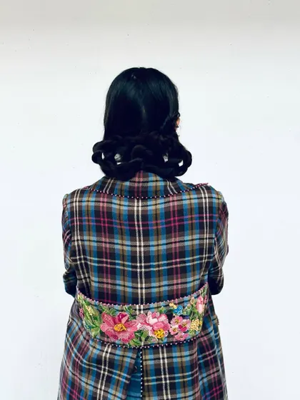 A detail shot of the back of this Pero coat, showcasing the beautiful floral embroidery that makes it so special.