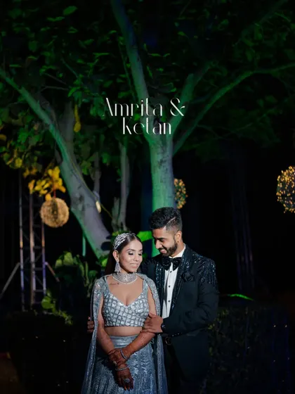 A romantic night portrait of Amrita and Ketan at their Sangeet. The beautifully lit tree in the background creates a magical, fairytale-like setting for the couple.